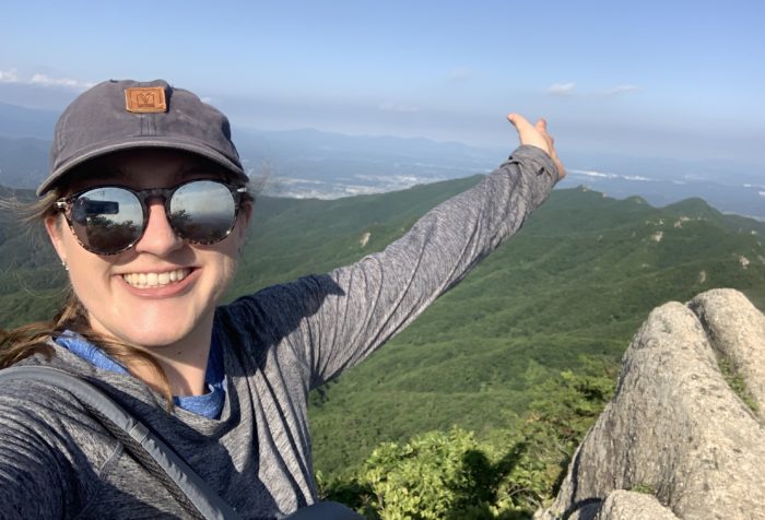 Jessica sitting atop a peak in the Palgongsan mountains in Daegu, South Korea.