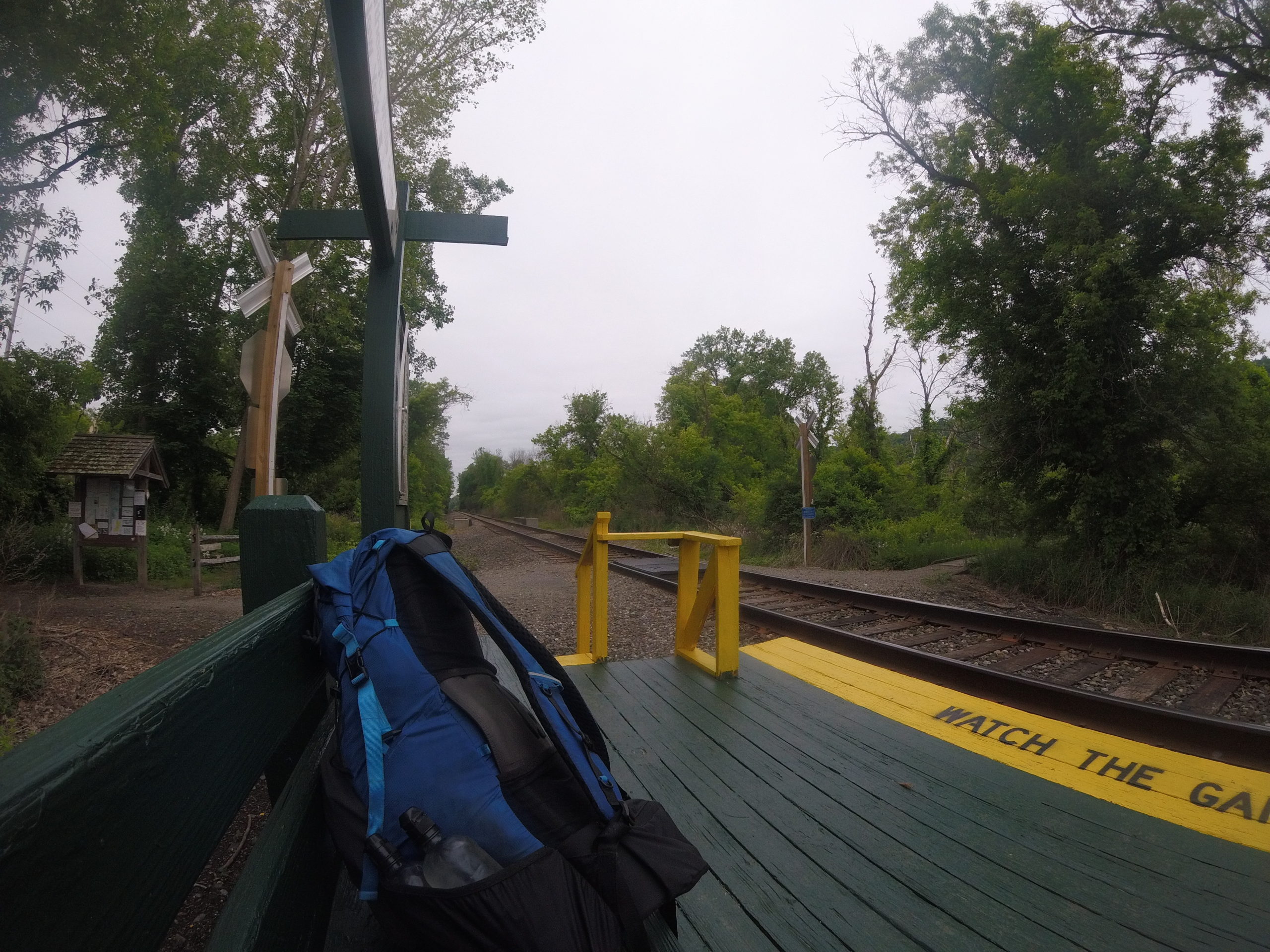 Blue backpack sits on bench at train station located in Pawling, NY on the Appalachian Trail