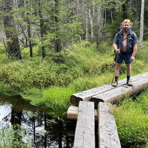 Tarzan standing on some newer bog boards heading NOBO to Piseco.