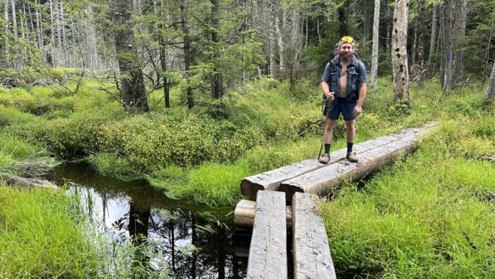 Tarzan standing on some newer bog boards heading NOBO to Piseco.