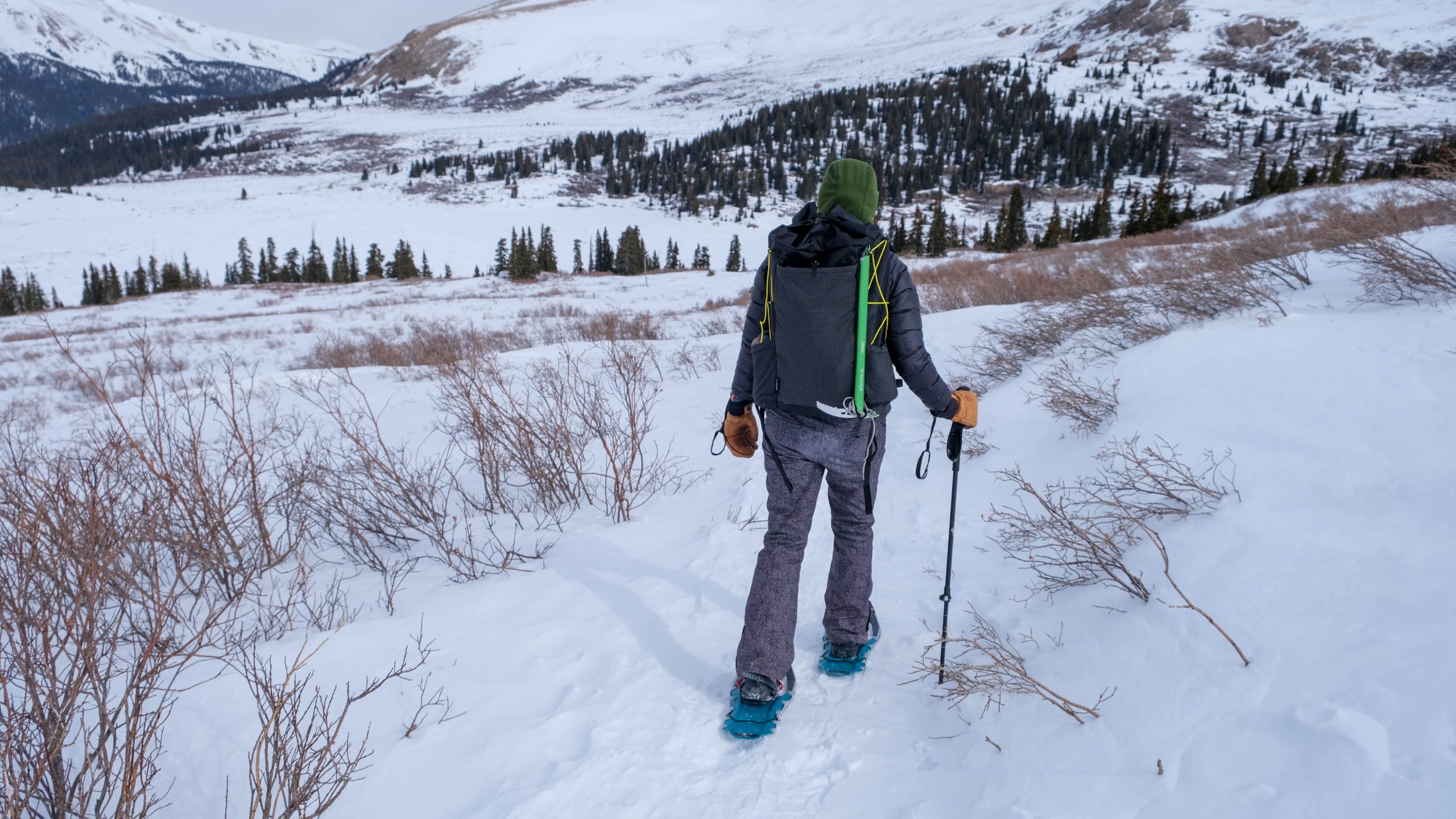 snowshoe hiker crosses snowy valley with six moon designs swift x