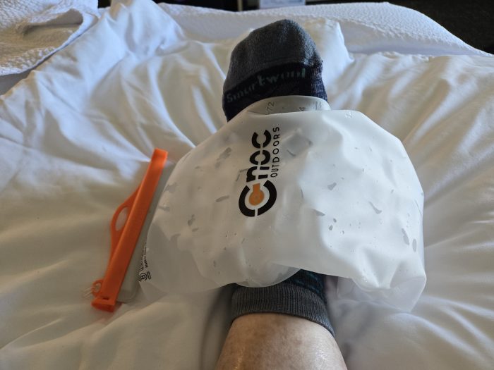 Ice filled cnoc water filter bag draped over injured foot.