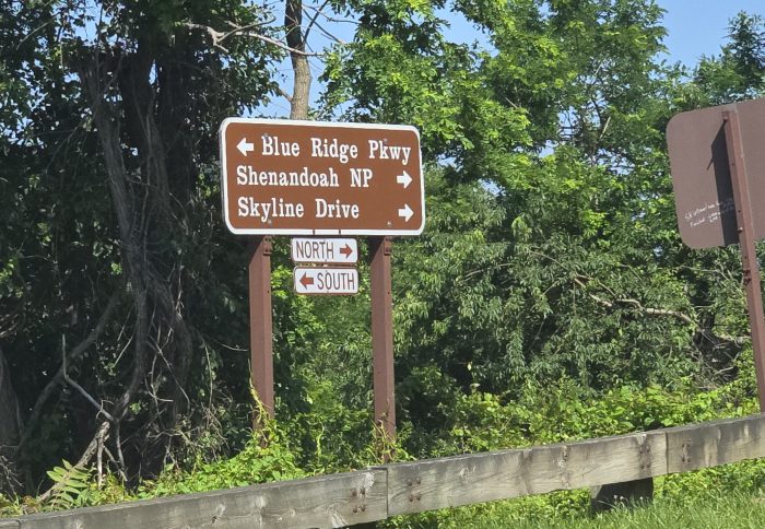 The brown road sign shown by the horizon led North and Blue Ridge Parkway South