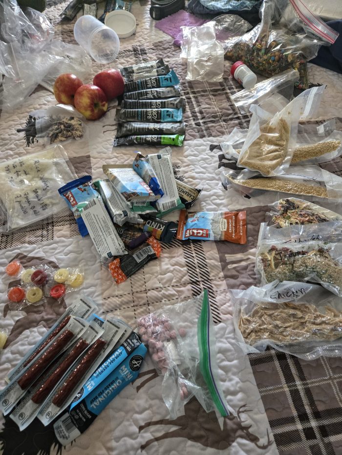 Food backpack scattered on a bed