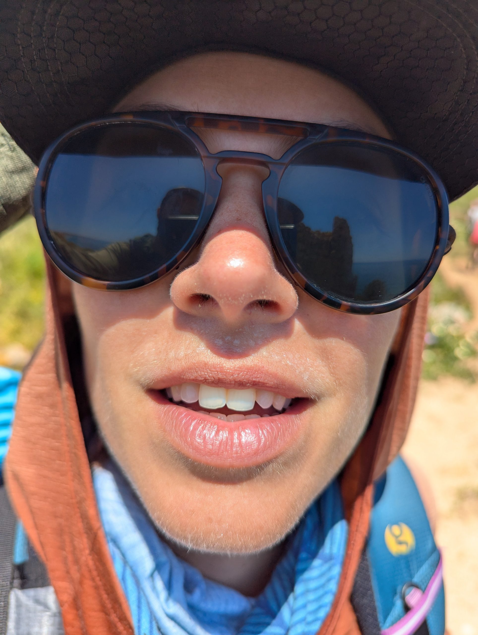 Hiker smiling with a visible sweat mustache after a hot day on the path of fishermen in Portugal