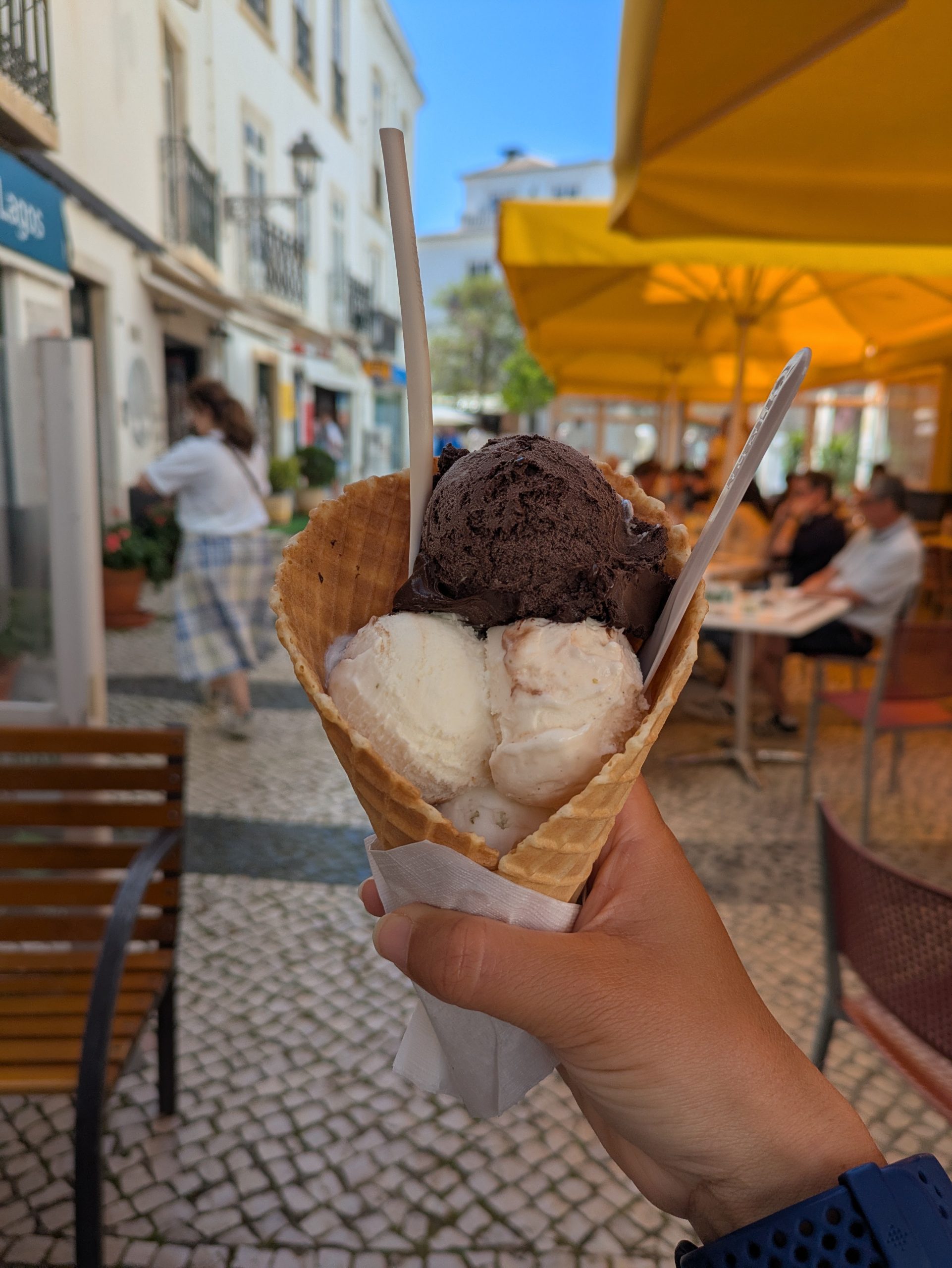 Waffle cone full of chocolate and espresso ice cream, sustained against a cobbled street curtain in lakes on the last day of the fishermen's path
