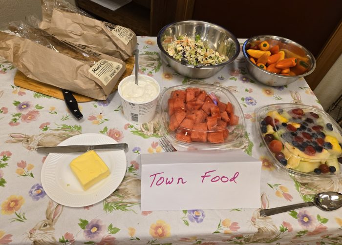 buffet with town food including bread and butter, fruits and vegetables