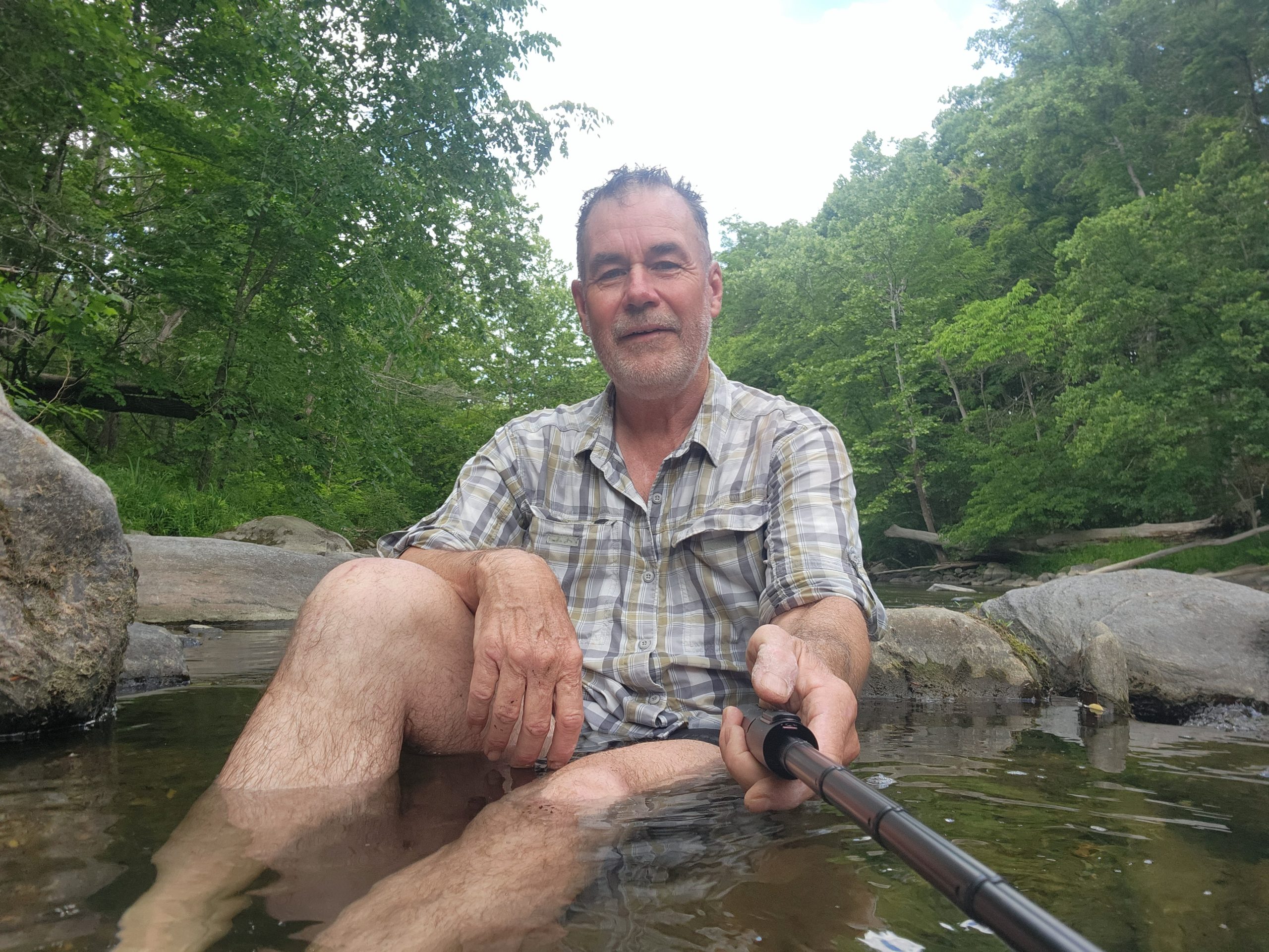 Hiker cooling off in the Tenmile River along the Appalachian Trail. Caption: Soaked in the Tenmile, with sweat trailing away.