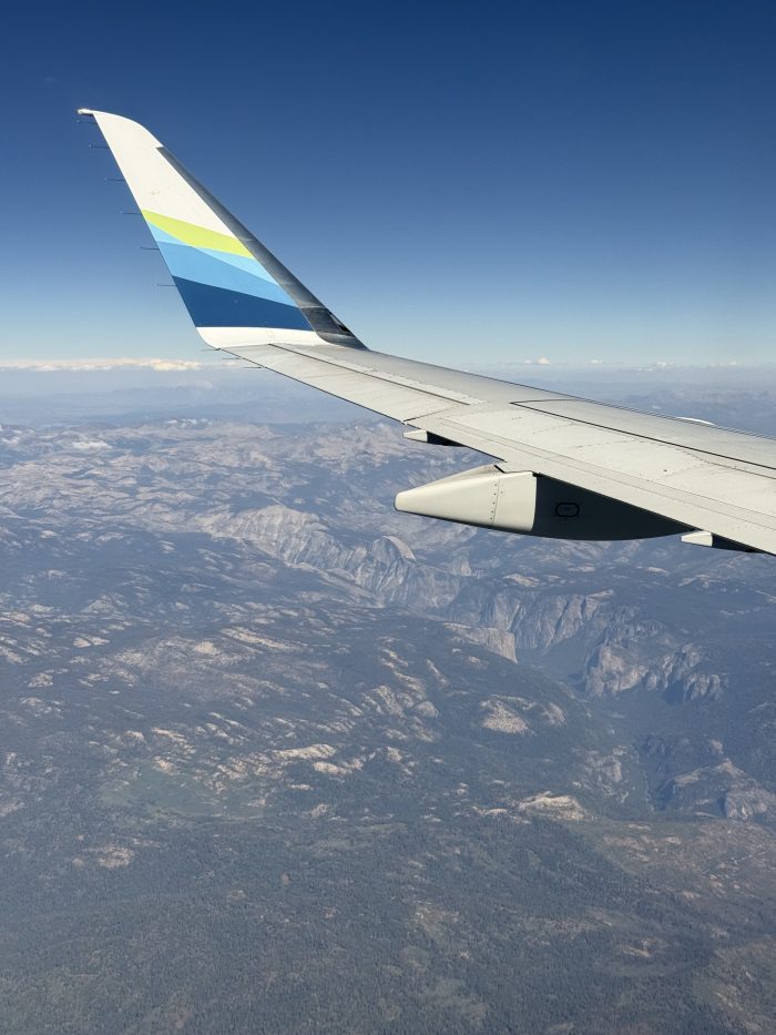 Airplane wing over view of Yosemite National Park