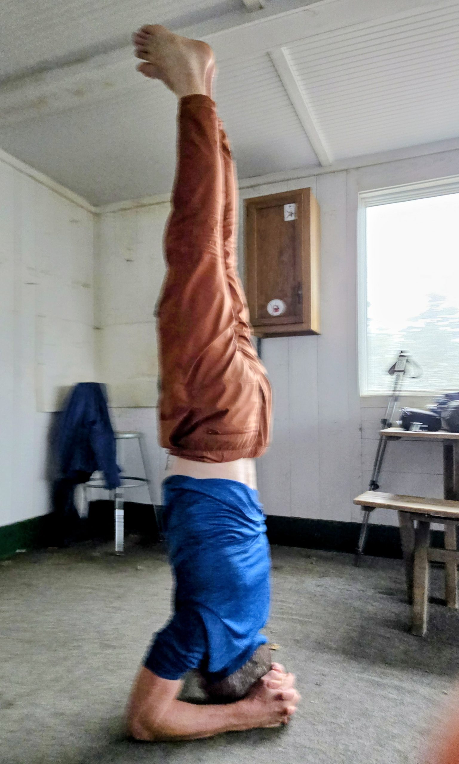man doing a yoga handstand