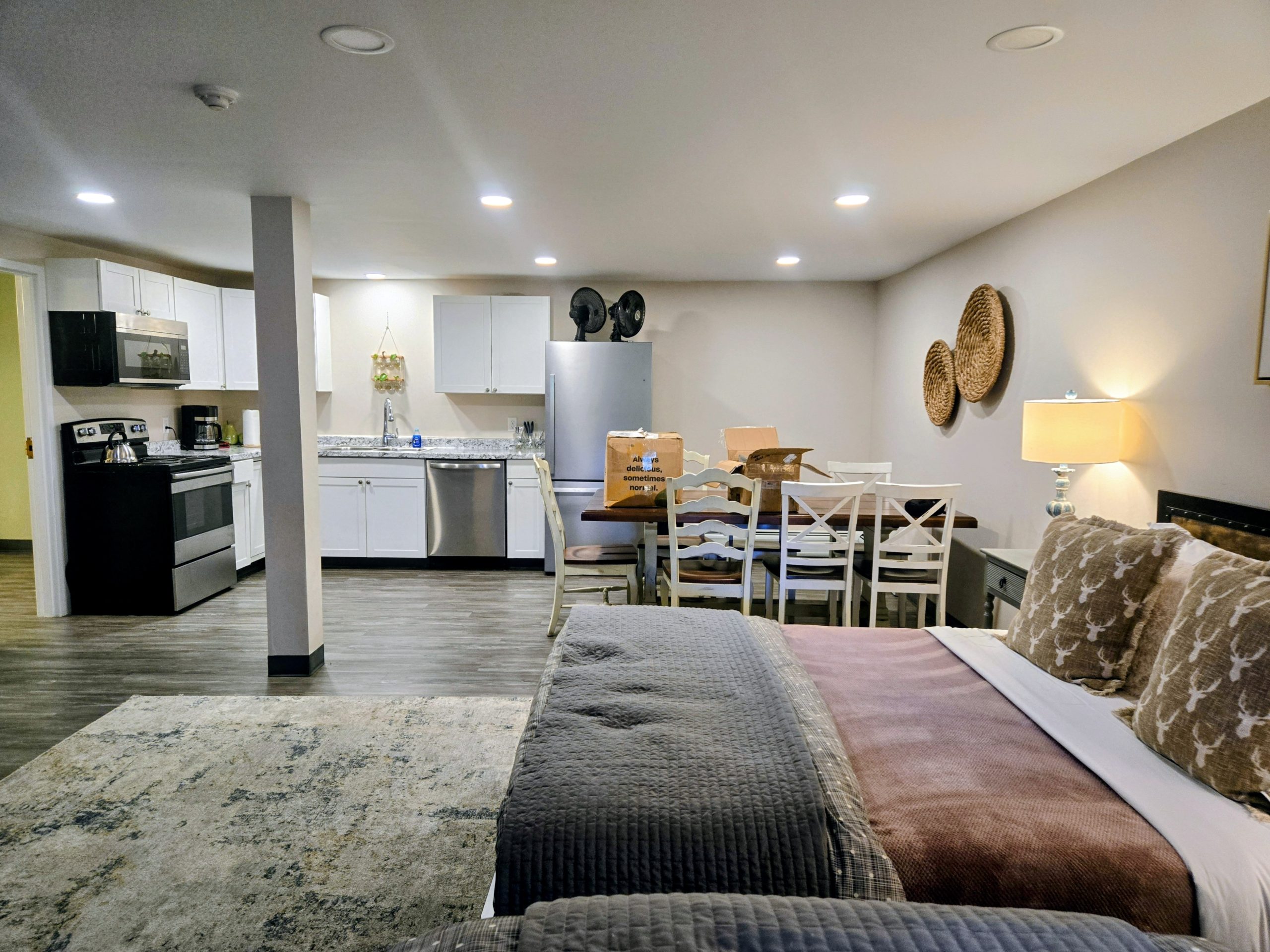 Interior shot of a efficiency apartment with a kitchen