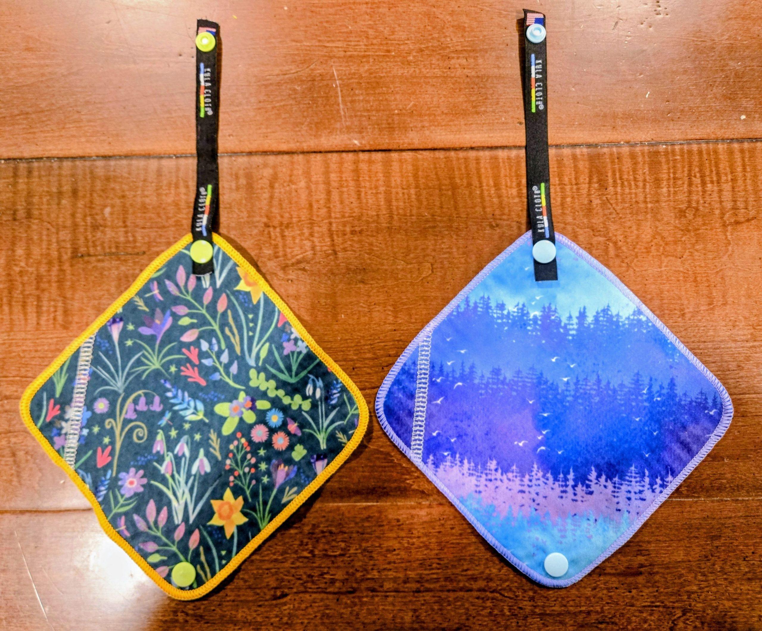 Two kula cloths, one green one blue, side by side.