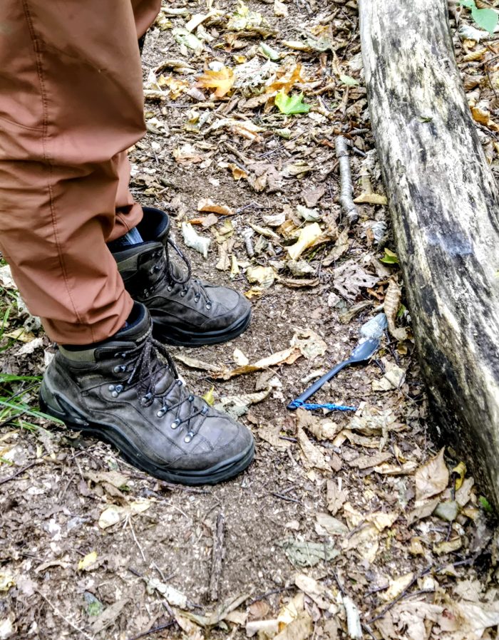Close up of two hikong boots and a spork on tje ground